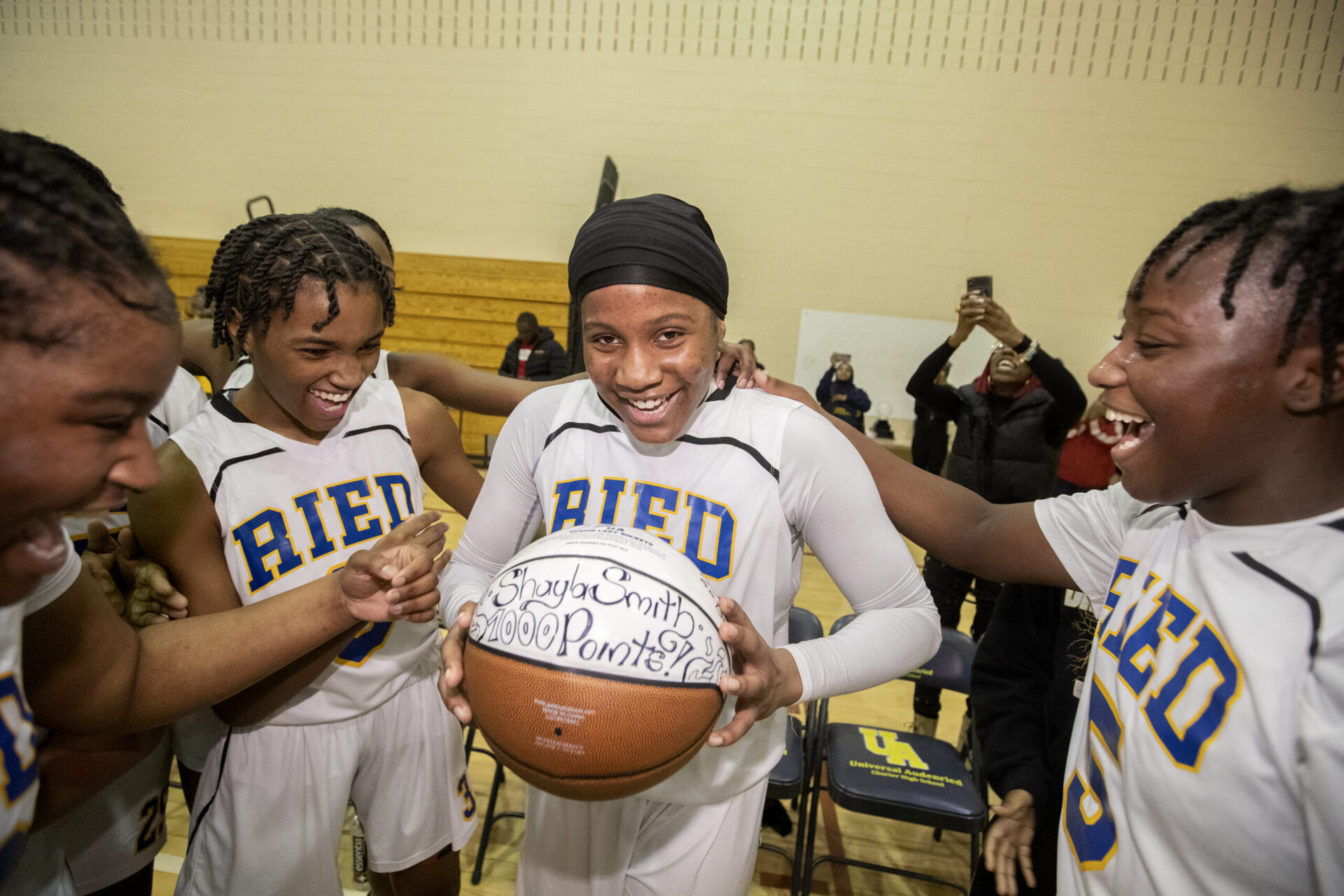 Shayla Smith of Universal Audenried is a dynamic sophomore guard and named the girls Philadelphia Public League player of the year. The sophomore became the fastest girl to score 1,000 points in the public league. Her teammates congratulate her after she went over 1,000 points in a playoff game against Masterman on Feb. 17, 2023.