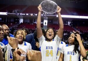 Shayla  Smith of Audenreid hold up the most valuable player award in the Philadelphia Girls Public League Championship at the Liacouras Center on Feb. 24, 2024.