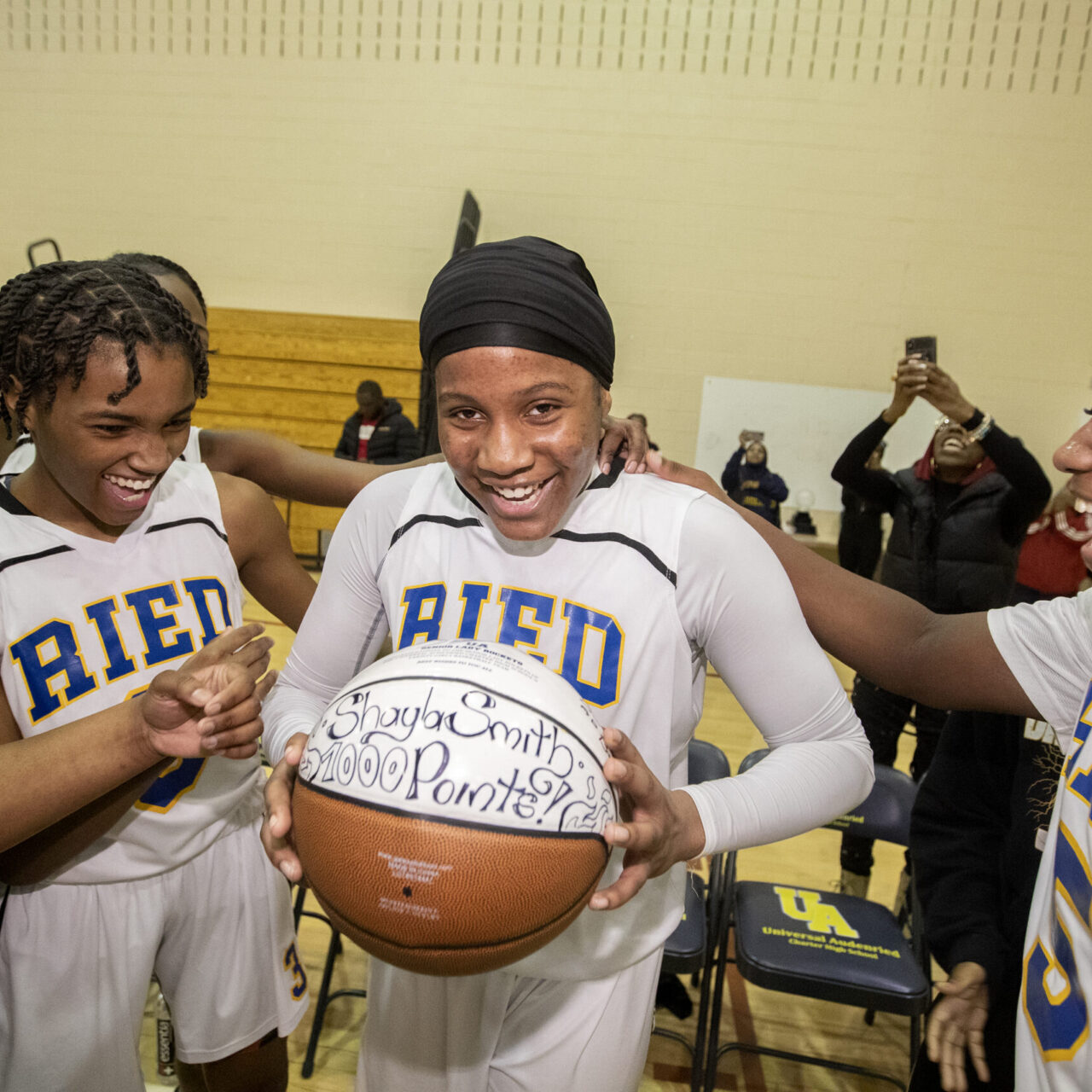 Shayla Smith of Universal Audenried is a dynamic sophomore guard and named the girls Philadelphia Public League player of the year. The sophomore became the fastest girl to score 1,000 points in the public league. Her teammates congratulate her after she went over 1,000 points in a playoff game against Masterman on Feb. 17, 2023.